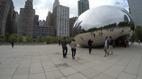 Walking on the famous Chicago Cloud Gate, The Bean Sculpture in Millennium Park, Chicago, Illinois