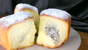 Buchty - Czech traditional sweet dessert sprinkled with powder sugar usually filled with poppy seeds, special jam (called povidla) or quark. Eating.