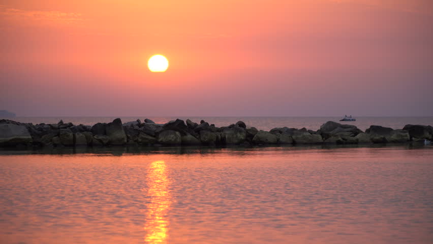 4K scenic red sunrise background sun rising. Close up video of sun rising behing sea