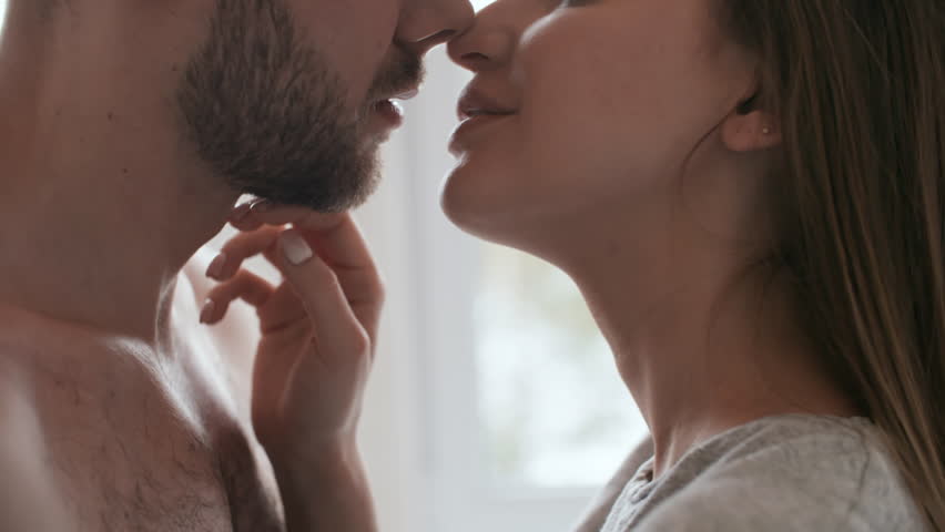 Woman kissing mans chest