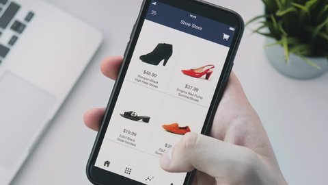 Shopping online using smartphone app and choosing shoes