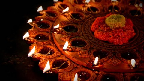 Diwali diya or oil lamp with flowers, gifts etc