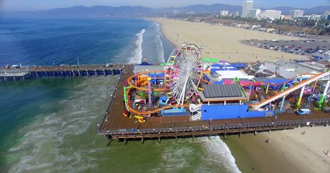 Aerial  view of Santa Monica Beach and famous iconic Pier landmark, Los Angeles, California, 4K