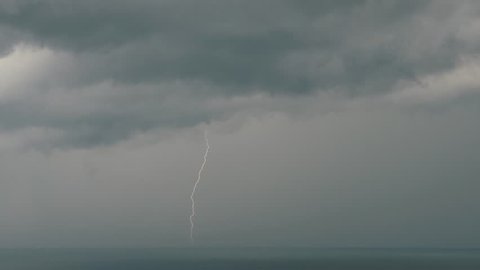 Lightning over the sea with dark clouds. Sea storm