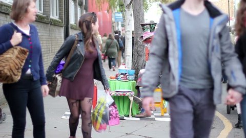 London, England - October 30 2017: Actor in the role of the mad hatter waits for tourists. Portobello Road