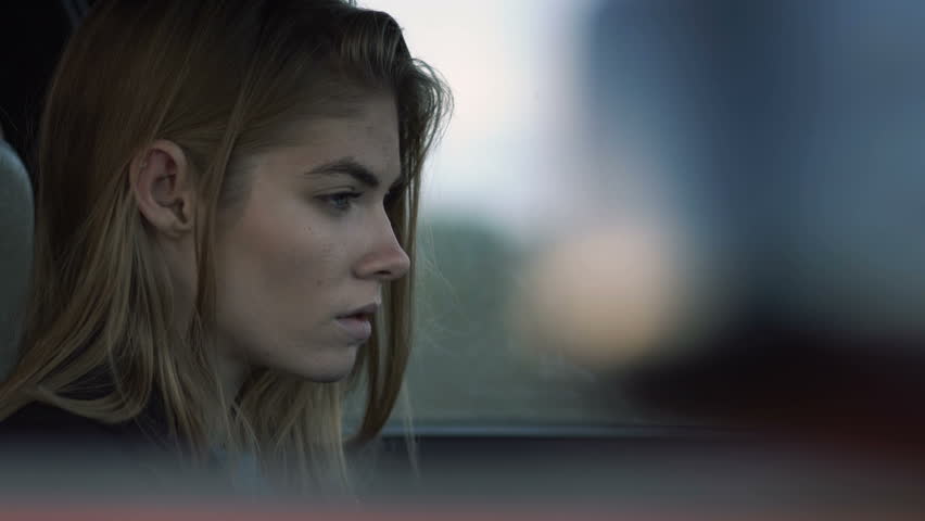 The girl is sad for driving a car, a model of a hipster in the car, Melancholy