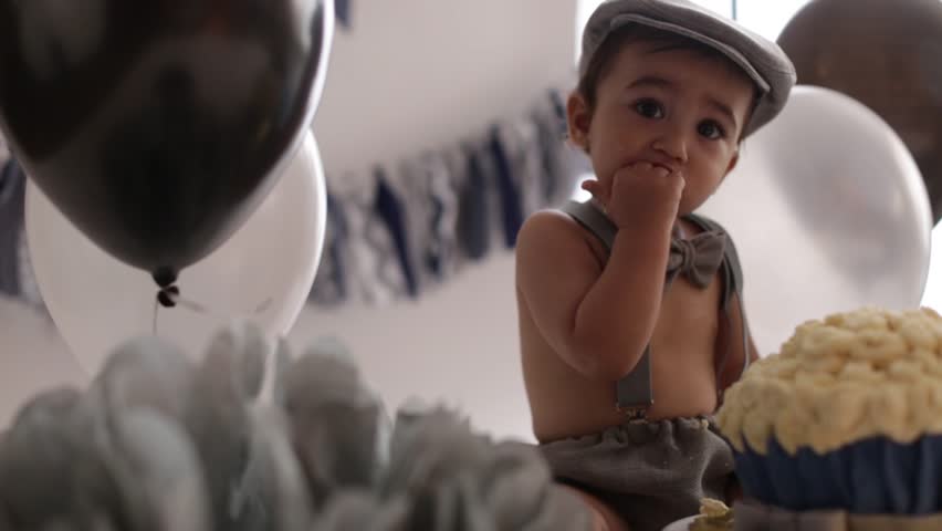 Infant boy's first birthday cake smash Adorable baby smashing cake