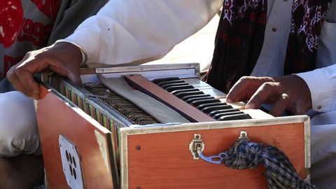 Close up shot of traditional musical instruments harmonium playing in Jaisalmer fort, Rajasthan, India