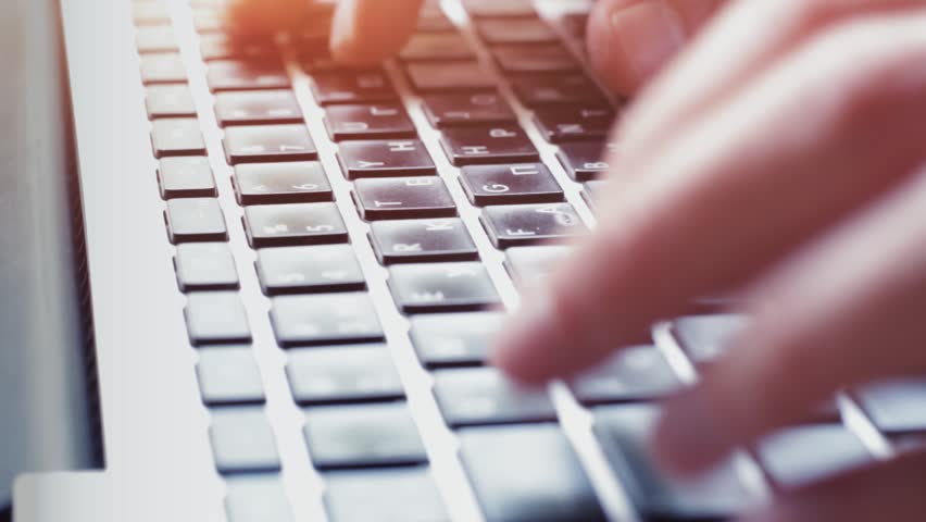 Video typing. Man hands typing on Computer Keyboard closeup.