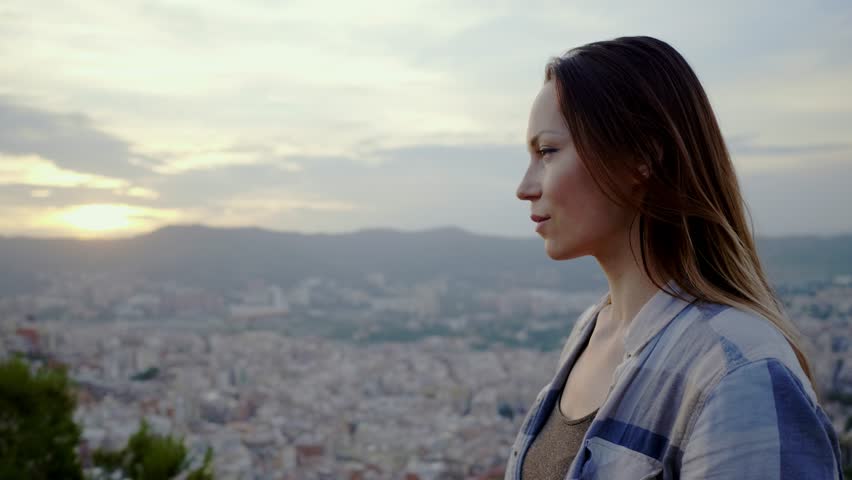 Beautiful woman enjoying Barcelona city view from Bunkers del Carmel, Spain