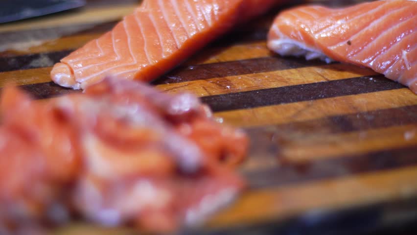 man cuts salmon closeup