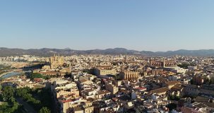 Aerial Drone of Old Town In Palma Mallorca Spain Skyline, Houses and Church Stone Buildings with Mountain Background at City Tourist Seaside Holiday Resort in the Summer.