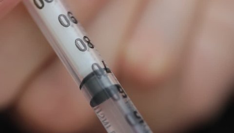 Syringe making contact with skin