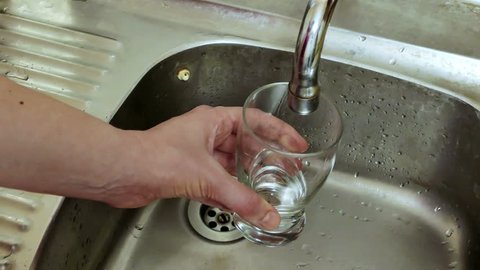 Glass Full of Dirty Water / Glass Full of Dirty Water Flowing from a Faucet