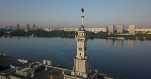 4K aerial video view of dilapidated Moscow Northern River Station with star spire and boat pier near Khimki, River Moscow, embankment and park area around it on summer morning in the capital of Russia