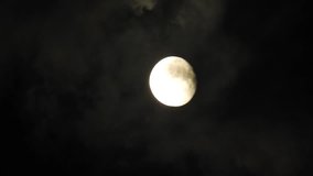 4k Moon in cloudy night sky close up video