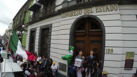 Puebla City, Puebla. Mexico. August 12, 2018. More than 8000 people asking to cancel the state elections for alleged electoral fraud. Pinatas and mexican flag in front of State Congress.