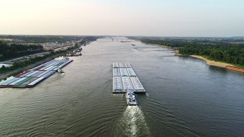 Aerial view of shipping barge transporting  goods up the Mississippi River on the Missouri and Illinois border. 
