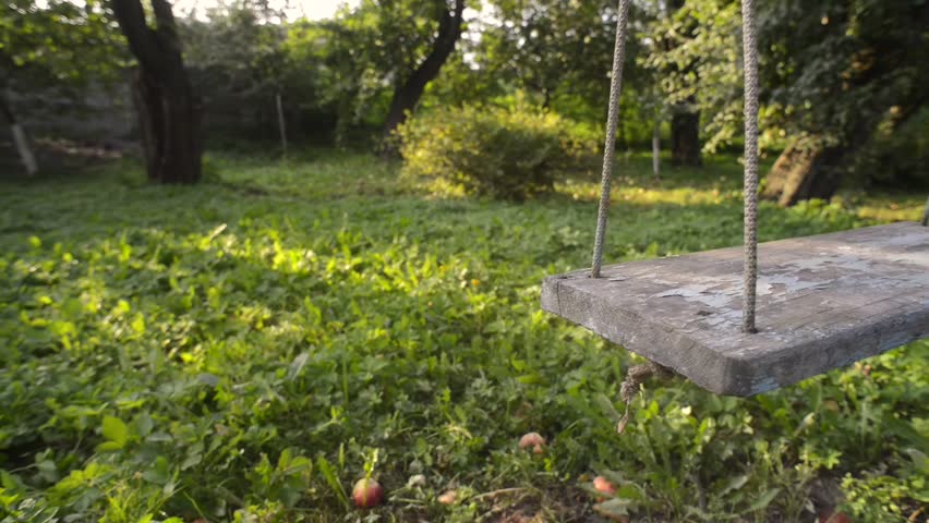 shaking garden swing closeup by summer evening, pan camera movement