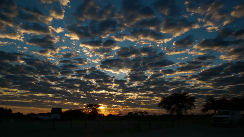 Beautiful cloudy sunrise timelapse over bush camp in Namibian wildlife reserve