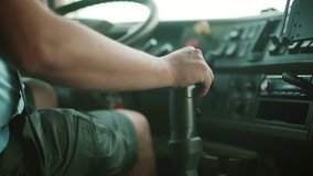 Dump Truck Driver At The Wheel and shift gear