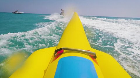 GoPro Footage of a Bananaboat. Riding a yellow Banana Boat in view of the person POV. Go Pro watersport fun on bananaboat.