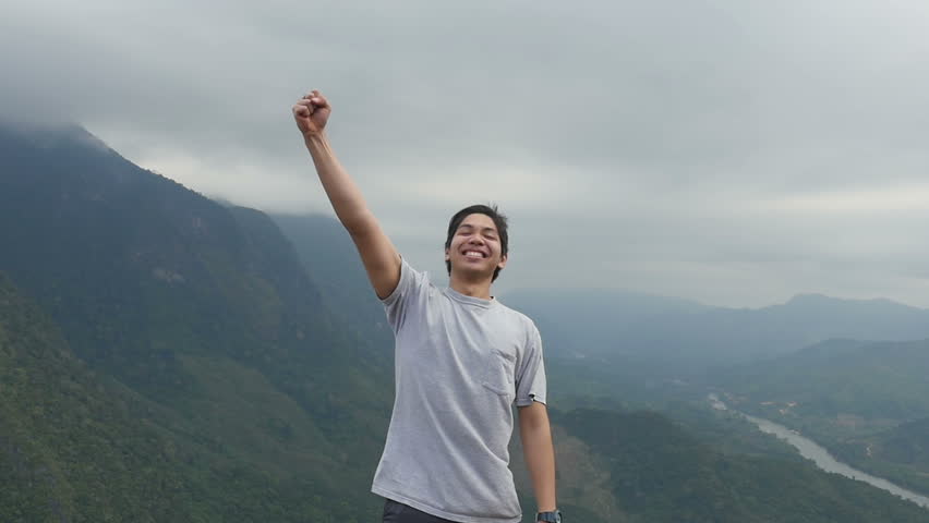 Young Asian Man Vitory On The Top Of Mountain
