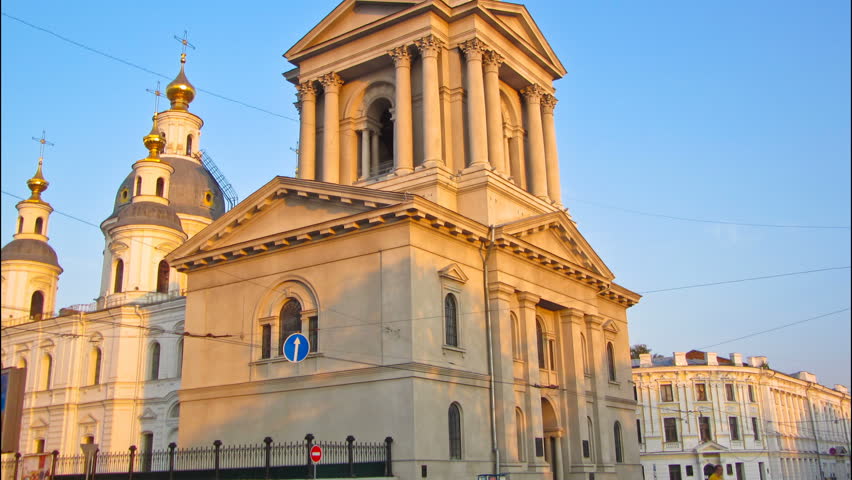 The bell tower of the Assumption Cathedral (Uspenskiy Sobor) timelapse hyperlapse, philharmonic organ hall at sunset in Kharkiv, Ukraine