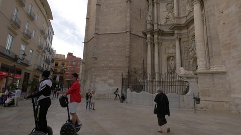 Valencia, Spain - April, 2017: Tourists walking by the Valencia Cathedral