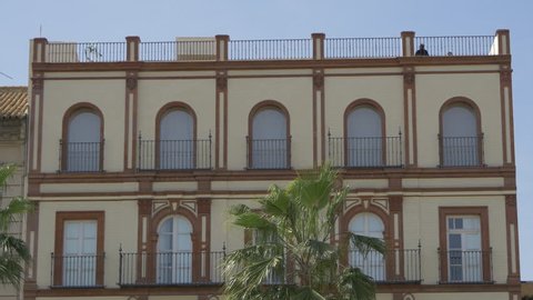 Seville, Spain - April, 2017: The top of a building with arched windows