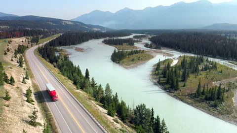Aerial view of truck driving on highway along the Athabasca River during summer in Jasper National Park, Canadian Rockies, Alberta, Canada. 