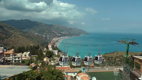 TAORMINA-May 2nd,2018-Cable car coming to Taormina, with beautiful bay in the background-May 2nd,2018