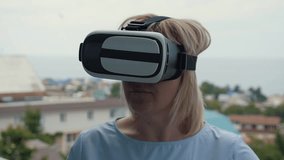 Blonde girl with virtual reality glasses. Modern technologies. The concept of virtual reality