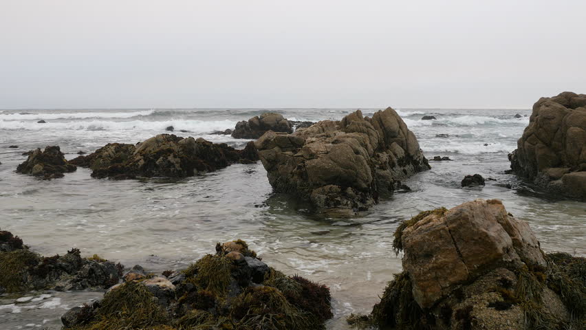 View of Ocean crashing against large rocks
