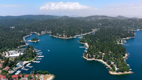 Aerial Shot Descending Over Lake Arrowhead with Water, Trees, Boats, and Lake Arrowhead Village all in View