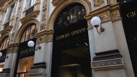 MILAN, ITALY - CIRCA MAY 2018: Shopping in the city. Gucci and Giorgio Armani boutiques in Galleria Vittorio Emanuele Milan, fashion