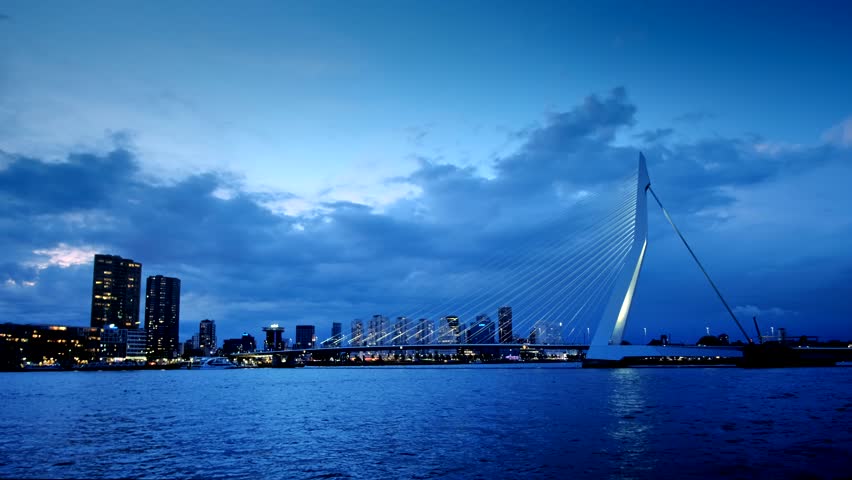 Erasmus Bridge (Erasmusbrug) and Rotterdam skyline illuminated at night. Rotterdam, Netherlands