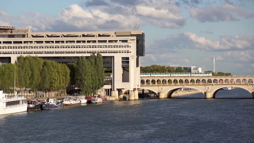 Metro crossing Bercy bridge with French Ministry for the Economy and Finance in background - Paris, France | Shutterstock HD Video #1014987577