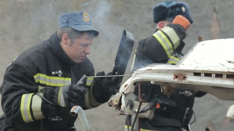 SEVASTOPOL,CRIMEA/RUSSIA-MARCH 19,2015:Firefighters working with welding, dismantling the car into parts on exercises on March 19, 2015 in Sevastopol, Russia