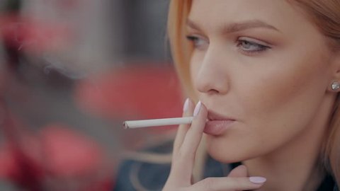 Beautiful blonde girl woman smoking cigarette