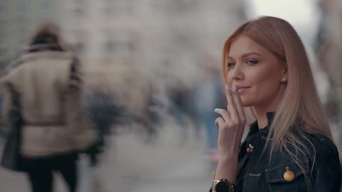 Beautiful blonde girl woman smoking cigarette 