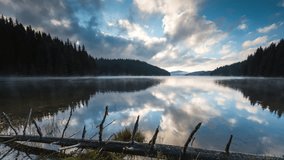 Timelapse with beautiful summer morning view of а mountain lake and moving clouds of Beglik dam in Rhodope Mountains, Bulgaria
