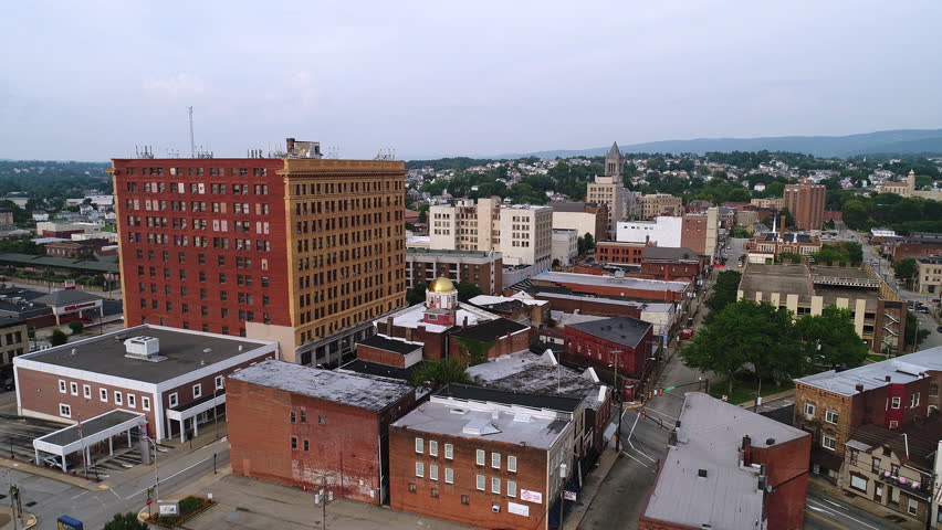 A slow forward moving aerial establishing shot of the small town of Uniontown, Pennsylvania, about 40 miles outside of Pittsburgh.  	
