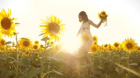 Cute child girl in yellow garden lifestyle of sunflowers sunlight in summer. beautiful sunset little girl in sunflowers. slow motion video. girl teenager and sunflowers field concept agriculture