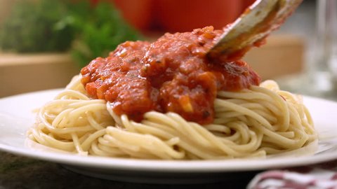 Eating spaghetti with marinara or tomato sauce, Italian cuisine. 