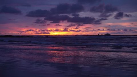 Beautiful out of focus background plate of orange, purple and blue sunset on the beach in Costa Rica for compositing or keying. Blurred defocused shot of ocean sun set for green screen composite. 4k