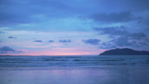 Out of focus background plate of beautiful purple and blue sunset on the beach in Costa Rica for compositing or keying. Blurred or defocused shot of ocean sun set for green screen composite. 4k