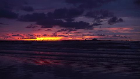 Gorgeous out of focus background plate of orange, purple and blue sunset on the beach in Costa Rica for compositing or keying. Blurred or defocused shot of ocean sun set for green screen composite. 4k