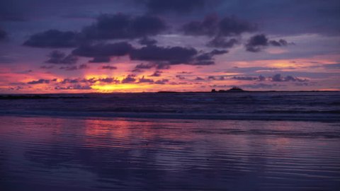 Out of focus background plate of gorgeous orange, purple and blue sunset on the beach in Costa Rica for compositing or keying. Blurred or defocused shot of ocean sun set for green screen composite. 4k