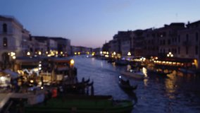 Panorama view of the Canale Grande at night with buildings receding in the distance. Gondolas crossing the channel in early evening. 4k